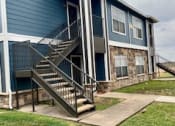 Thumbnail 5 of 10 - a blue house with stairs in front of it