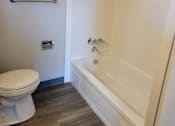 Thumbnail 8 of 9 - a small bathroom with a toilet and a bathtub
