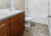 Thumbnail 17 of 48 - A bathroom with a sink, toilet, and a shower.