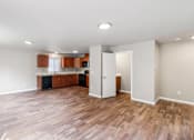 Thumbnail 7 of 48 - A kitchen with wooden floors and white walls.