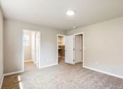 Thumbnail 14 of 48 - A spacious room with carpeted floor and white walls.