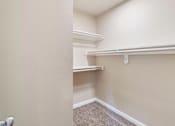 Thumbnail 12 of 48 - A room with a carpeted floor and a white door.