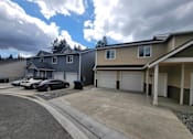 Thumbnail 5 of 48 - A row of houses with a car parked in front of the first house.