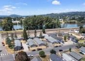 Thumbnail 27 of 34 - an aerial view of a subdivision with a river and mountains in the background