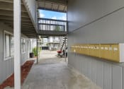 Thumbnail 30 of 34 - a hallway with a staircase leading up to an apartment building