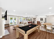 Thumbnail 2 of 17 - A billiard table is in the middle of a well-furnished room.