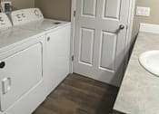 Thumbnail 40 of 48 - A white bathroom with a toilet, sink, and a door.