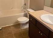 Thumbnail 82 of 82 - A white toilet is mounted on a brown wall in a bathroom.
