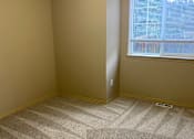 Thumbnail 71 of 82 - A room with a window and a carpeted wall.