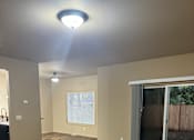 Thumbnail 48 of 82 - A room with a window and a ceiling fan.