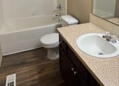 Thumbnail 51 of 82 - A white sink is mounted on a beige wall in a bathroom.