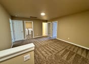 Thumbnail 18 of 48 - A spacious room with carpeted floor and white trim.