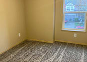Thumbnail 36 of 82 - A room with a window and a carpeted wall.