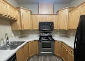 Thumbnail 61 of 82 - A kitchen area with a microwave and oven built into the cabinetry.