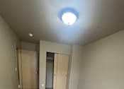 Thumbnail 58 of 82 - A room with a light on the wall and a wooden structure.