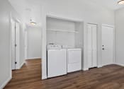 Thumbnail 9 of 42 - A laundry room with a washer and dryer.
