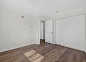 Thumbnail 19 of 42 - A room with a white door and a white cabinet.