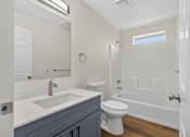Thumbnail 20 of 42 - A bathroom with a white toilet and a white sink.