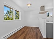 Thumbnail 15 of 42 - A room with a window and a wooden floor.