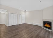 Thumbnail 35 of 42 - A room with a fireplace and wooden flooring.