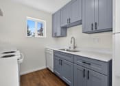 Thumbnail 12 of 42 - A kitchen with a white stove and a white refrigerator.
