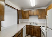Thumbnail 13 of 36 - an empty kitchen with white appliances and wooden cabinets