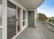Thumbnail 22 of 36 - the view from the balcony of a home with a large screen door to the patio