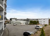 Thumbnail 31 of 36 - an office building with cars parked in a parking lot