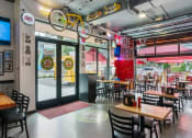 Thumbnail 19 of 20 - a restaurant with tables and chairs and a bicycle hanging from the ceiling at The Hub, Washington, 98503