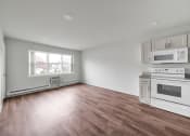 Thumbnail 7 of 27 - Living room with kitchen at Amity Senior, Amityville, NY 11701