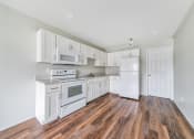 Thumbnail 3 of 27 - Kitchen with appliances and cabinets at Amity Senior, Amityville, NY 11701