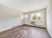 Thumbnail 20 of 27 - Living room with fireplace and window at Amity Senior, Amityville, NY 11701