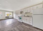 Thumbnail 16 of 27 - Kitchen and living area with wooden floor at Amity Senior, Amityville, NY, 11701