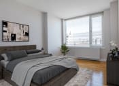Thumbnail 7 of 20 - an apartment bedroom with a bed and a large window