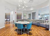Thumbnail 24 of 26 - A conference room with a round table and blue chairs.