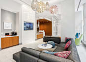 Thumbnail 16 of 26 - A modern living room with a grey sofa and a coffee table.