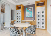 Thumbnail 23 of 26 - A modern kitchen with a dining table and chairs.