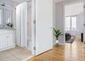 Thumbnail 9 of 20 - a living room with white walls and a bamboo floor