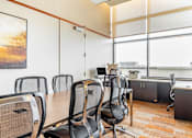 Thumbnail 24 of 25 - A conference room with a long table and chairs.