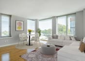 Thumbnail 4 of 20 - a living room with a white couch and a table with chairs at 34 Berry, Brooklyn, NY, 11249