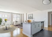 Thumbnail 3 of 20 - a kitchen with a island and a living room with a couch at 34 Berry, Brooklyn, NY