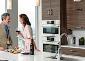 Thumbnail 12 of 24 - Couple talking in modern kitchen at Altaire, Virginia