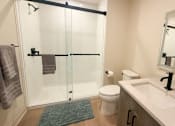 Thumbnail 7 of 20 - A bathroom with a toilet, sink, and shower.at The Jones Tower at the Collective, Pittsburgh, PA 15203