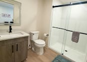 Thumbnail 18 of 20 - A bathroom with a toilet, sink, and shower.at The Jones Tower at the Collective, Pittsburgh, PA 15203