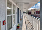 Thumbnail 2 of 22 - a balcony with a view of a parking lot