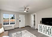 Thumbnail 5 of 22 - an open living room with a large window and a ceiling fan