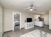 Thumbnail 8 of 22 - an open living room and kitchen with a bedroom in the background
