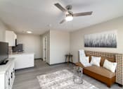 Thumbnail 17 of 22 - a living room with a couch and a ceiling fan