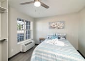 Thumbnail 16 of 22 - a bedroom with a large bed and a ceiling fan