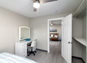 Thumbnail 10 of 22 - a bedroom with a desk and a mirror